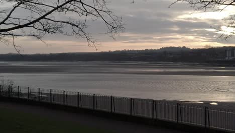 Slow-motion-sunrise-parallax-across-glowing-urban-waterfront-regeneration-Mersey-River-promenade
