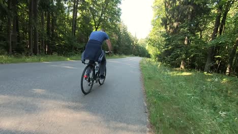 A-man-rides-his-bike-through-the-forest