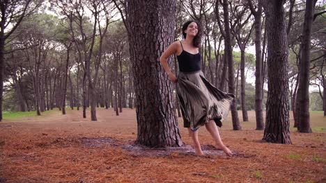 A-Barefooted-Woman-Happily-Twirling-Around-The-Tree-In-In-The-Core-Of-The-Forest