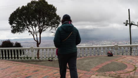 Woman-walking-through-the-sanctuary-of-Guadalupe-to-the-viewpoint-of-the-Bogota-city