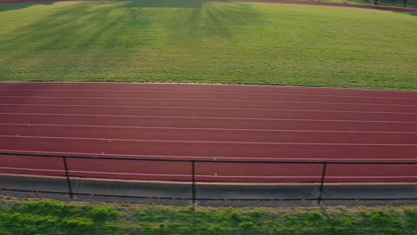 A-teen-girl-track-athlete-runs-track-as-camera-tracks-left