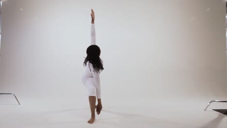 Black-yogini-moves-from-warrior-poses-to-triangle-pose