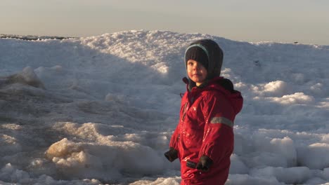 Child-watching-waves-crash-on-ice