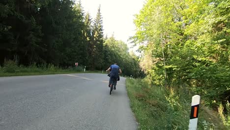 Man-rides-a-bicycle-through-the-woods