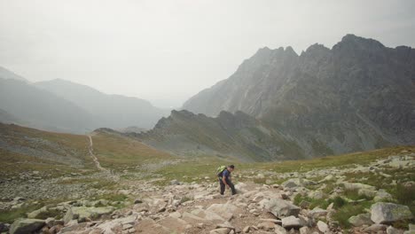 Hiker-walking-up-the-beautiful-mountain-and-enjoying-the-view