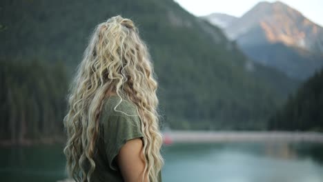 Slow-Motion-Shot-of-a-happy-beautiful-blonde-female-overlooking-a-gorgeous-scene-in-the-mountains-3
