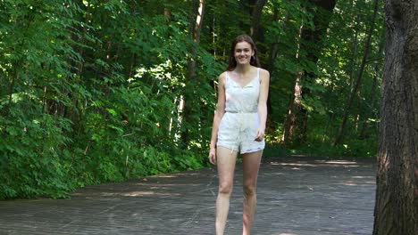 Full-length-view-of-young-woman-walking-on-park