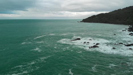 Blue-ocean-sea-and-waves-coast-from-Stirling-Point,-Bluff-,-New-Zealand-on-cloudy-day---Aerial-Drone-shot-of