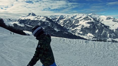 A-kid-snowboarding-down-the-ski-run