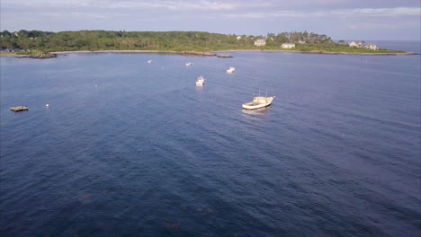 Aerial-shot-flying-over-commercial-fishing-and-lobster-boats-in-the-blue-Atlantic-waters-off-the-Maine-coast