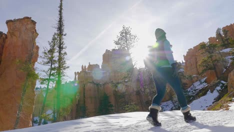 Girl-woman-hiking-with-red-rocks-formation-and-snow-near-Bryce-Canyon-in-southern-Utah-3