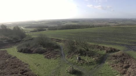 Idyllic-British-farming-meadows-countryside-fields-aerial-view-orbit-left-above-rustic-scenic-vista