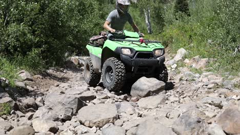 Slow-motion-shot-of-an-ATV-Rider-driving-his-quad-down-an-extremely-rocky-path-in-the-Wasatch-Mountains