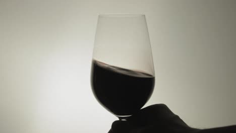 Shaking-A-Glass-Of-Wine-With-A-Hand-In-A-Steady-Position---Close-Up-Shot