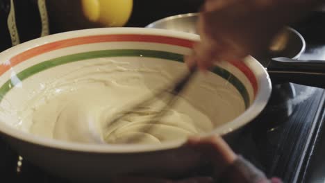 Mixing-Well-The-Pancake-Batter-In-A-Mixing-Bowl-Until-Smooth-Using-A-Flat-Plastic-Whisk---Close-Up-Shot