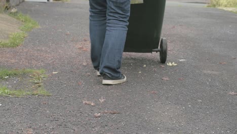 Moving-green-recycling-wheelie-bin-for-waste-collection-1