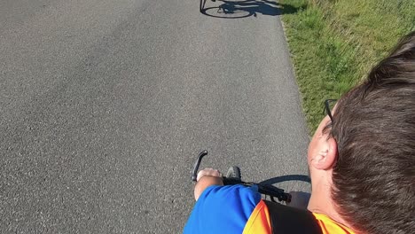 A-cyclist-wearing-an-orange-vest-rides-his-bike