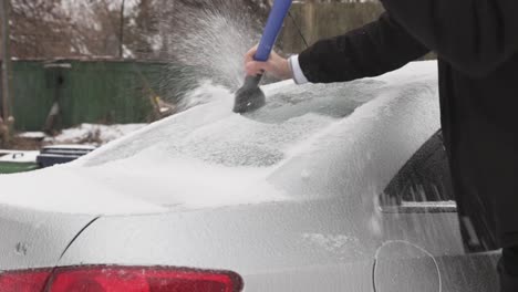 A-Man-Scraping-Ice-Off-The-Car-On-A-Winter-Day---Close-Up-Shot
