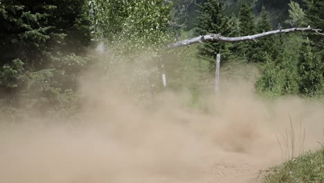 Slow-motion-shot-of-an-ATV-Rider-driving-his-quad-off-of-a-small-jump-and-getting-a-little-bit-of-air-time