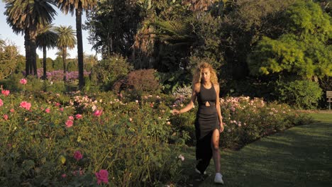 Beautiful-Woman-Walking-Through-A-Flower-Garden---In-Centennial-Park---Sydney-Australia-On-A-Sunny-Day---Wide-Shot