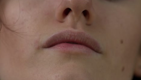 Closeup-shot-of-a-womans-mouth-and-nose,-completely-natural-without-makeup