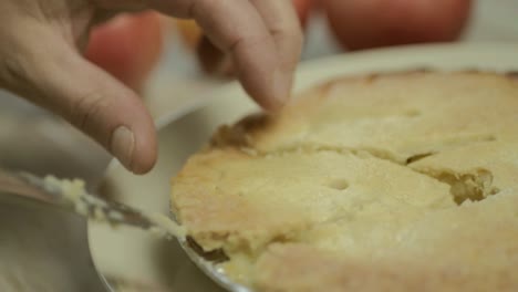 Cutting-a-portion-of-apple-pie-dessert-with-knife