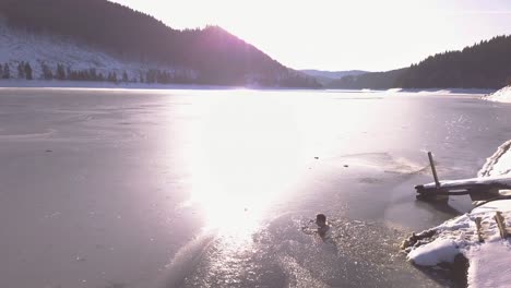 Young-man-in-frozen-lake-sits-down-in-ice-cold-water