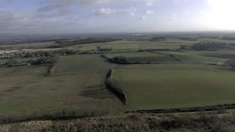 Idyllic-British-farming-meadows-countryside-fields-aerial-view-slow-aerial-shot