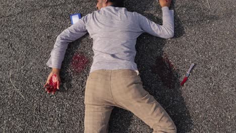 Pan-view-from-top-to-bottom-of-a-dead-body,-Concept-of-Crime-scene,-a-dead-body-after-murder-laying-on-the-roadside