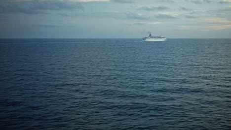 Cruise-ship-in-ocean-with-small-waves-and-in-a-distance