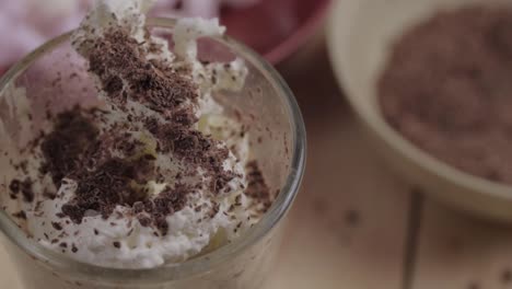 Sprinkles-of-chocolate-on-hot-drink-with-whipped-cream