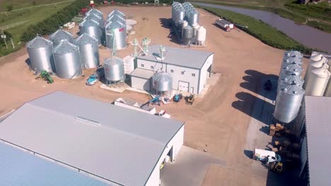 Aerial-view-of-the-storage-bins,-warehouses,-tractors-and-trailers-of-a-cover-seed-agribusiness-in-Nebraska-USA,-but-exports-seeds-around-the-world