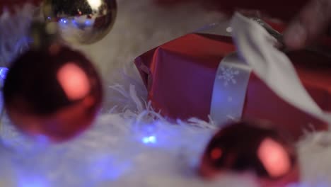 Unwrapping-a-Christmas-gift-wrapped-with-red-paper-and-bow-with-red-bauble-1