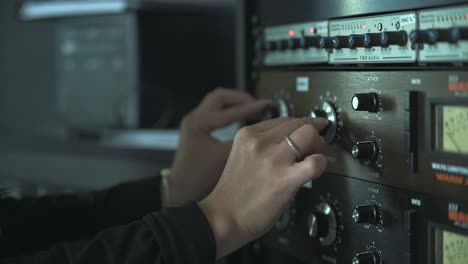 Woman-radio-host-adjusting-Settings-On-Mixer-Console