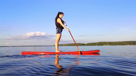 There-is-young-girl-paddle-boarding-in-the-big-lake