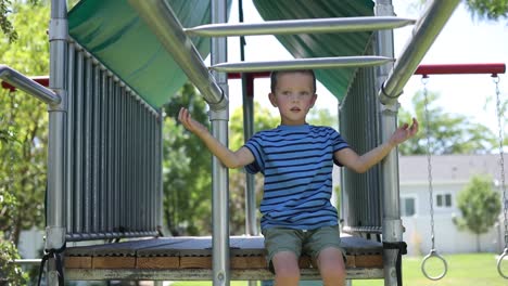 Slow-Motion-shot-of-a-young-boy-playing-on-the-monkey-bars-on-a-playground-set-in-his-backyard-3