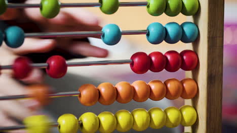 Young-boy-playing-with-a-colourful-abacus-in-slow-motion