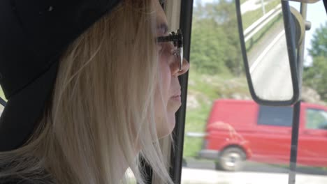 Happy-smiling-female-adult-driving-on-road-trip-close-up