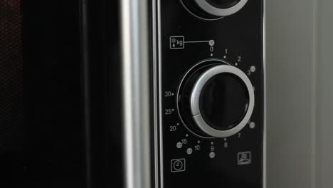 Setting-microwave-timer-to-twenty-minutes-and-turning-microwave-off---close-angled-shot