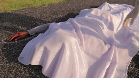 Concept-of-Crime-scene-road-accident,-Close-up-of-covering-chalk-outlined-dead-body-on-road