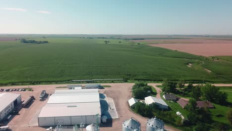 Aerial-view-of-the-storage-bins-and-warehouses-of-a-cover-seed-agribusiness-in-the-USA,-but-exports-seeds-around-the-world