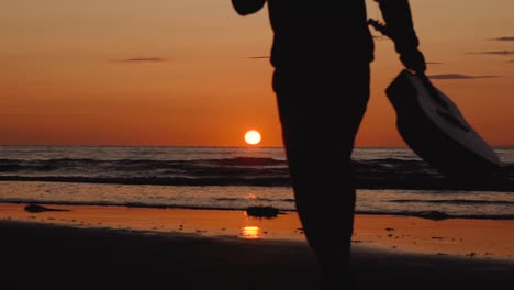 Man-running-with-guitar-in-back-sand-beach-at-sunset-13