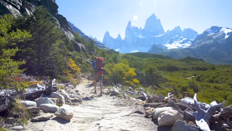 "Young-woman-wearing-backpack-hiking-on-a-trail-in-Patagonia,-Argentina