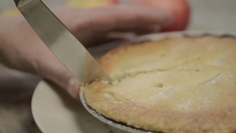 Cutting-a-portion-of-apple-pie-dessert-with-knife-1