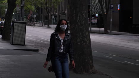 Woman-walking-down-bourke-st-wearing-mask-during-covid19-Melbourne