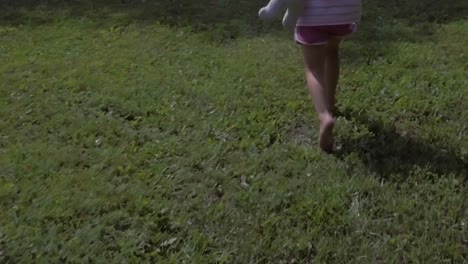 Girly-feet-walking-and-running-off-on-grass-field-in-slow-motion