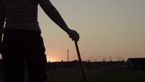 Woman-and-walking-stick-silhouette-at-sunset