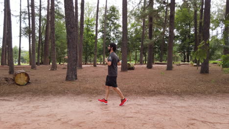 Man-running-in-the-middle-of-pine-forest