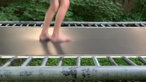 Bare-feet-jump-up-and-down-on-a-trampoline-in-slow-motion