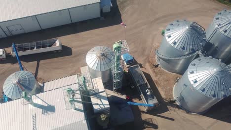Drone-aerial-view-of-a-trailer-being-loaded-at-an-agribusiness-that-exports-cover-seeds-located-in-Nebraska-USA-1